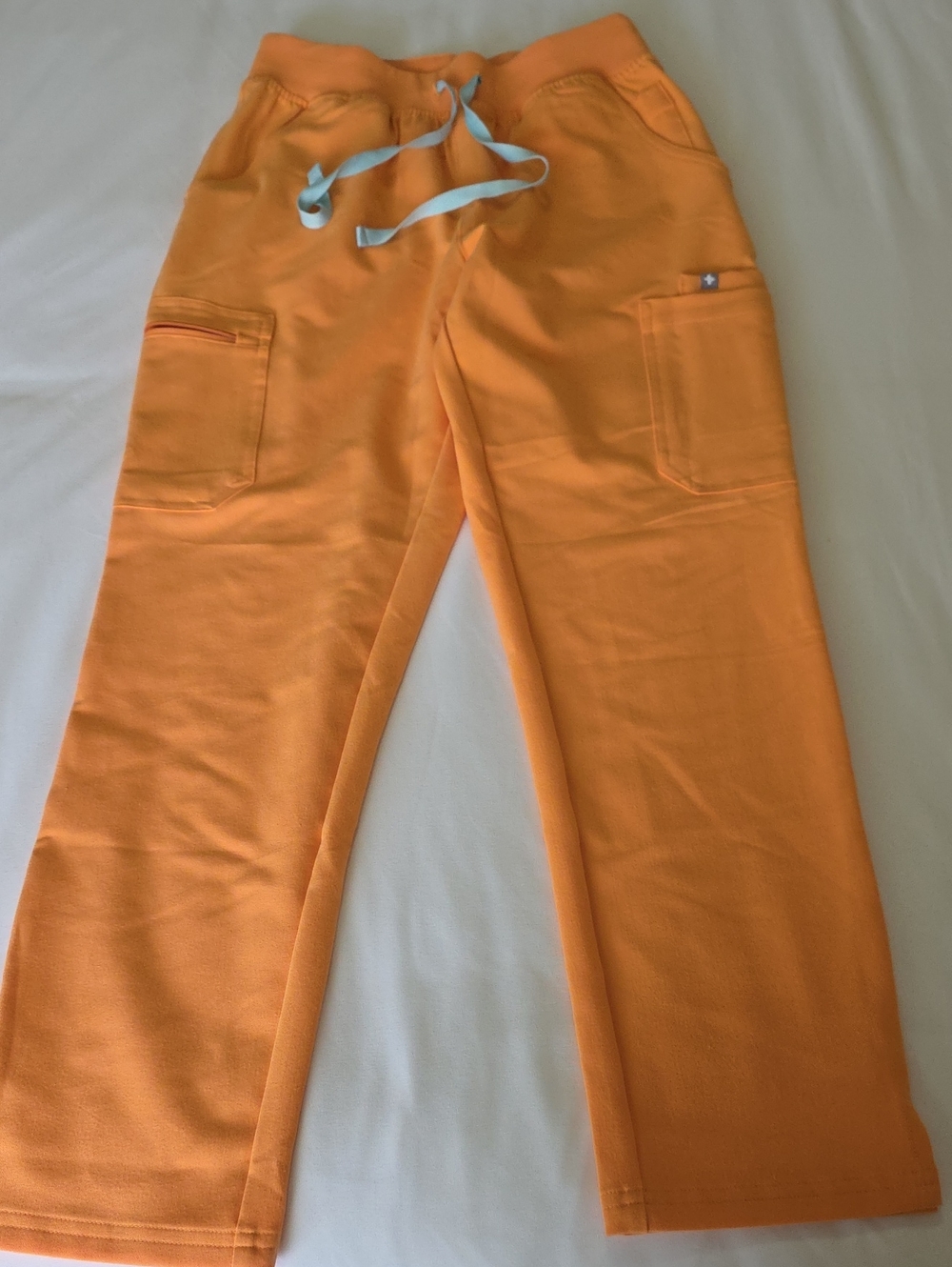Figs Women's Cargo Scrub Pants in Bright Orange with Light Blue Drawstring